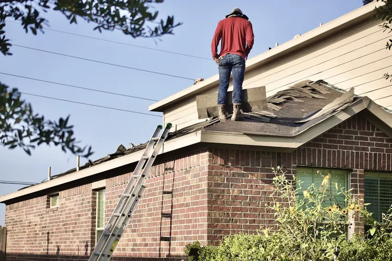Professional roofer working on a residential roof in Casitas Springs